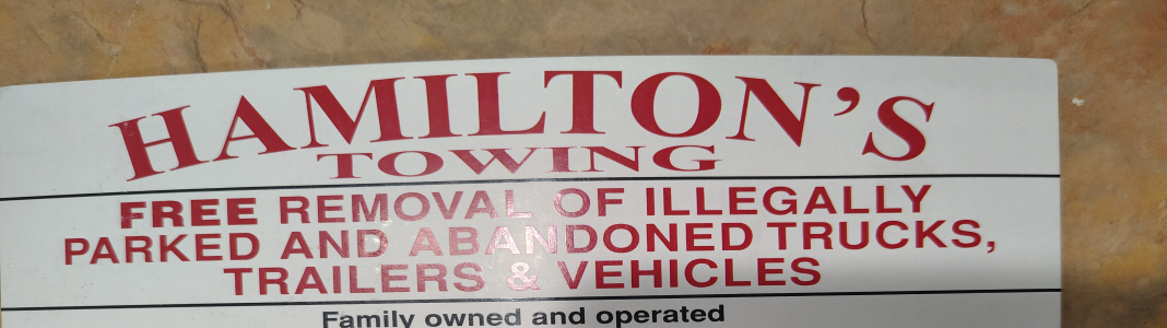 Hamilton's Tow For Less company banner